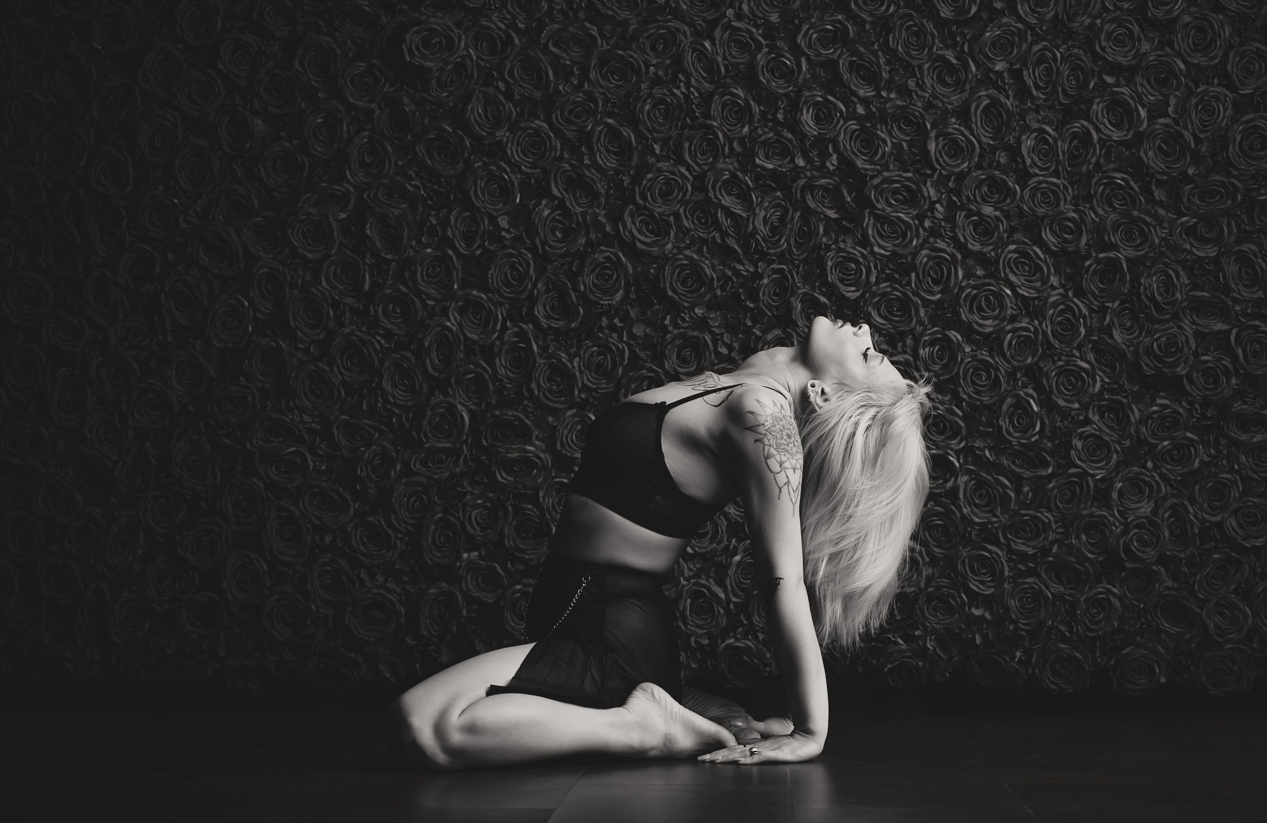 Black and white image series showing a ballet dancer performing graceful movements in a dark studio setting.