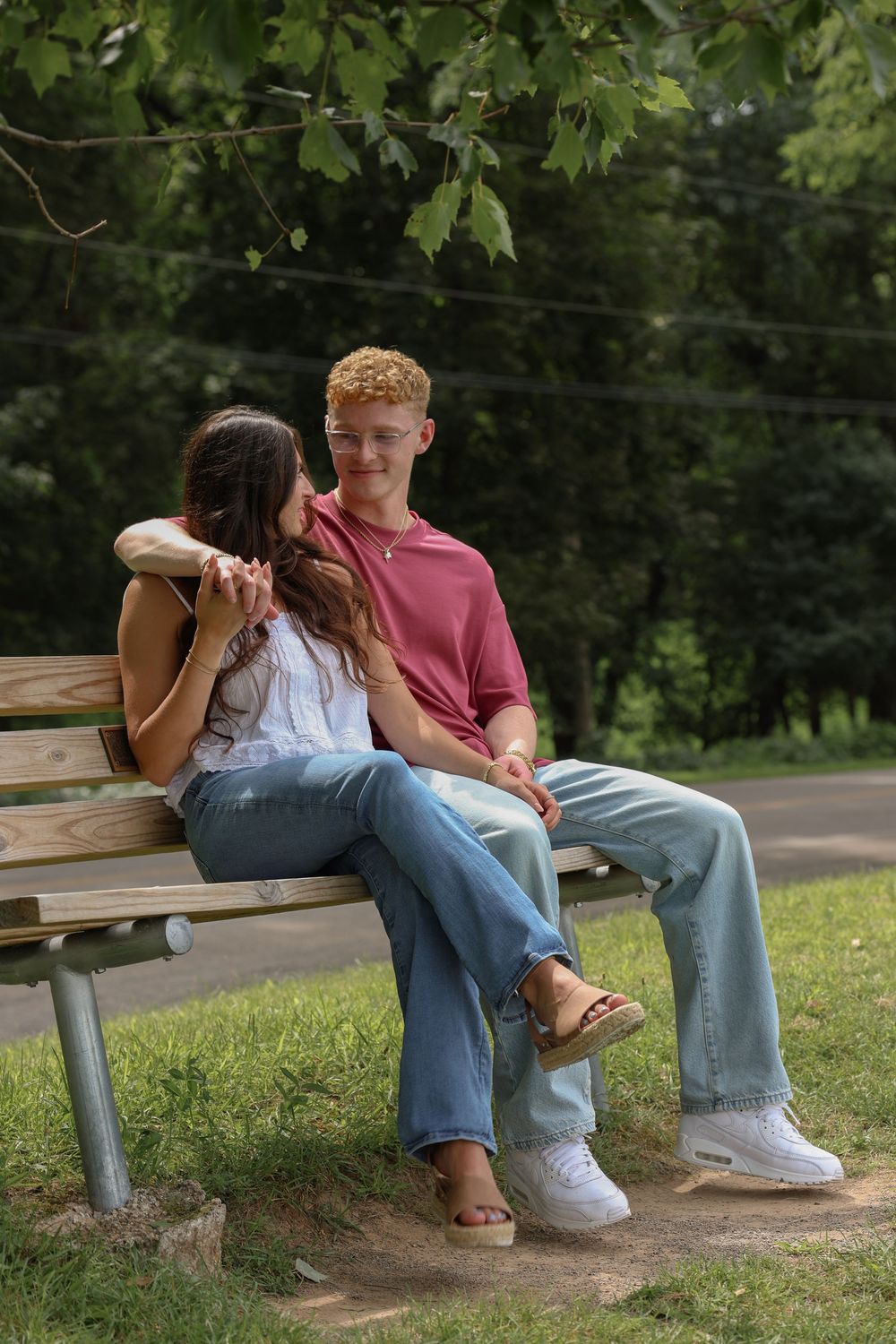 Man and woman sitting on bench and looking at each other