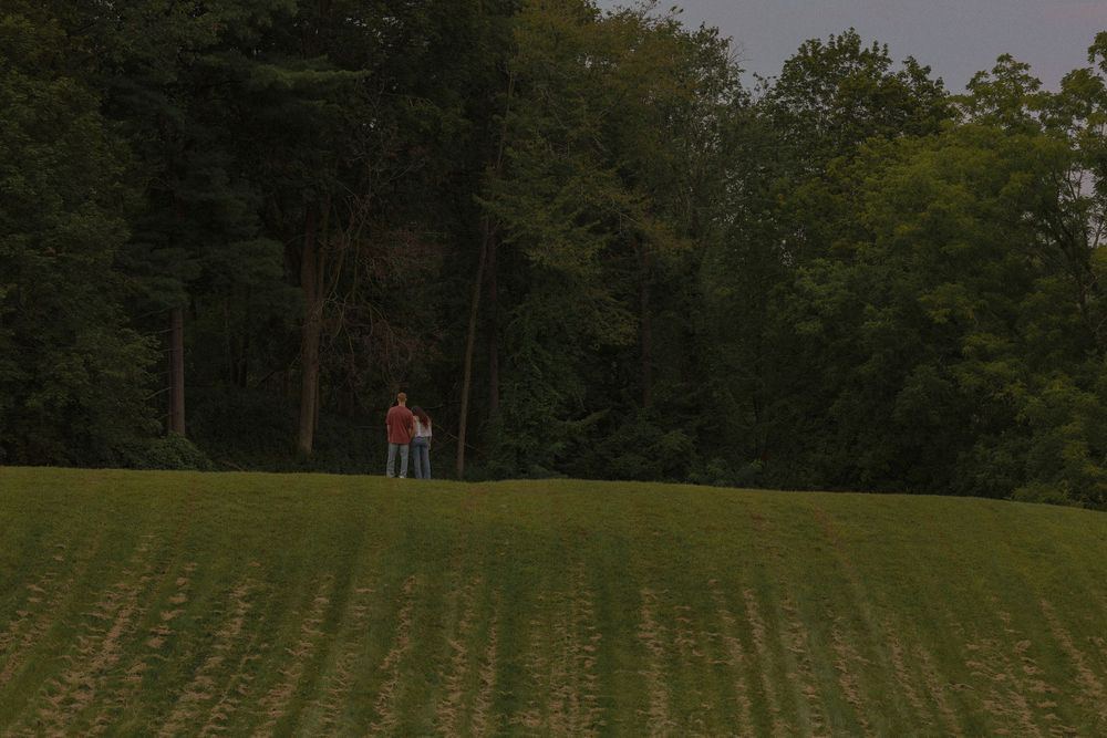 Man and woman off in the distance on a hill