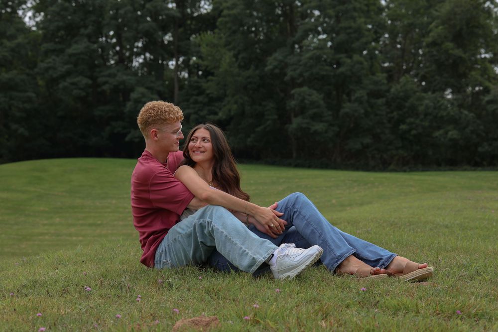 Man and woman sitting in field together