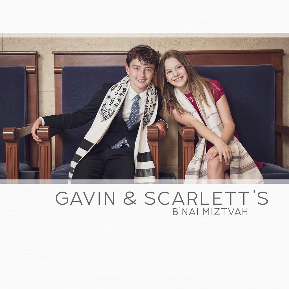 Young people in formal attire pose together at a B'nai Mitzvah celebration with navy blue backdrop.