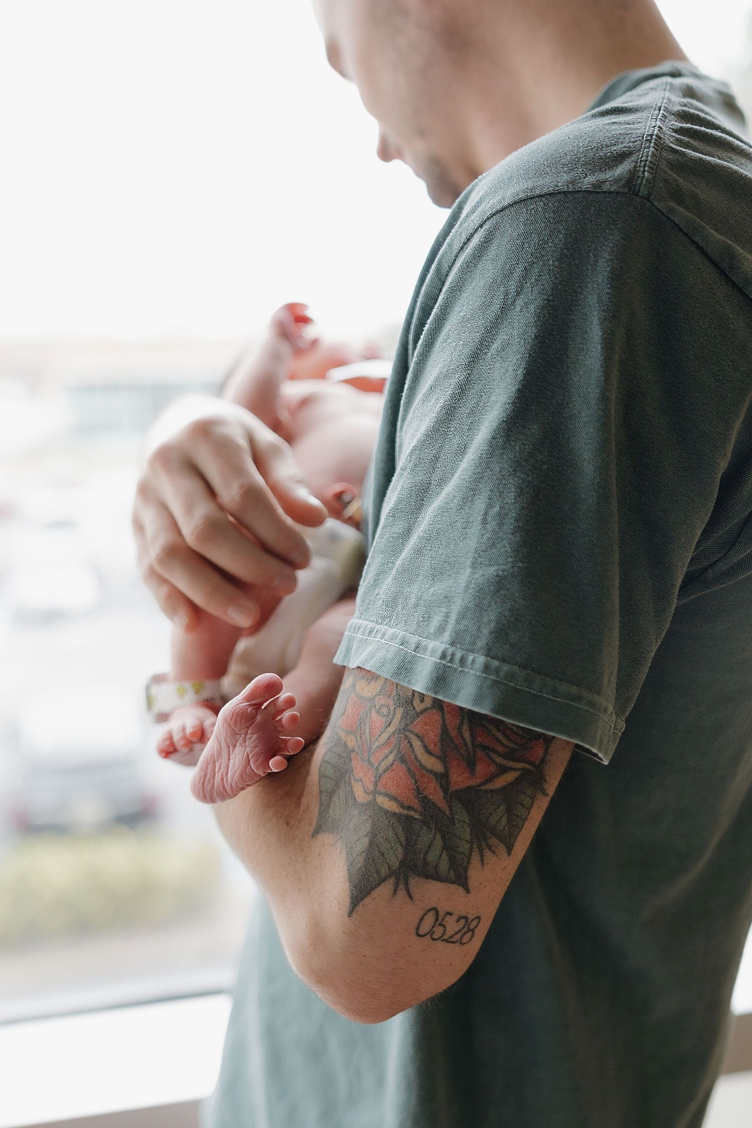 Close-up shots of tattooed arm in green t-shirt.