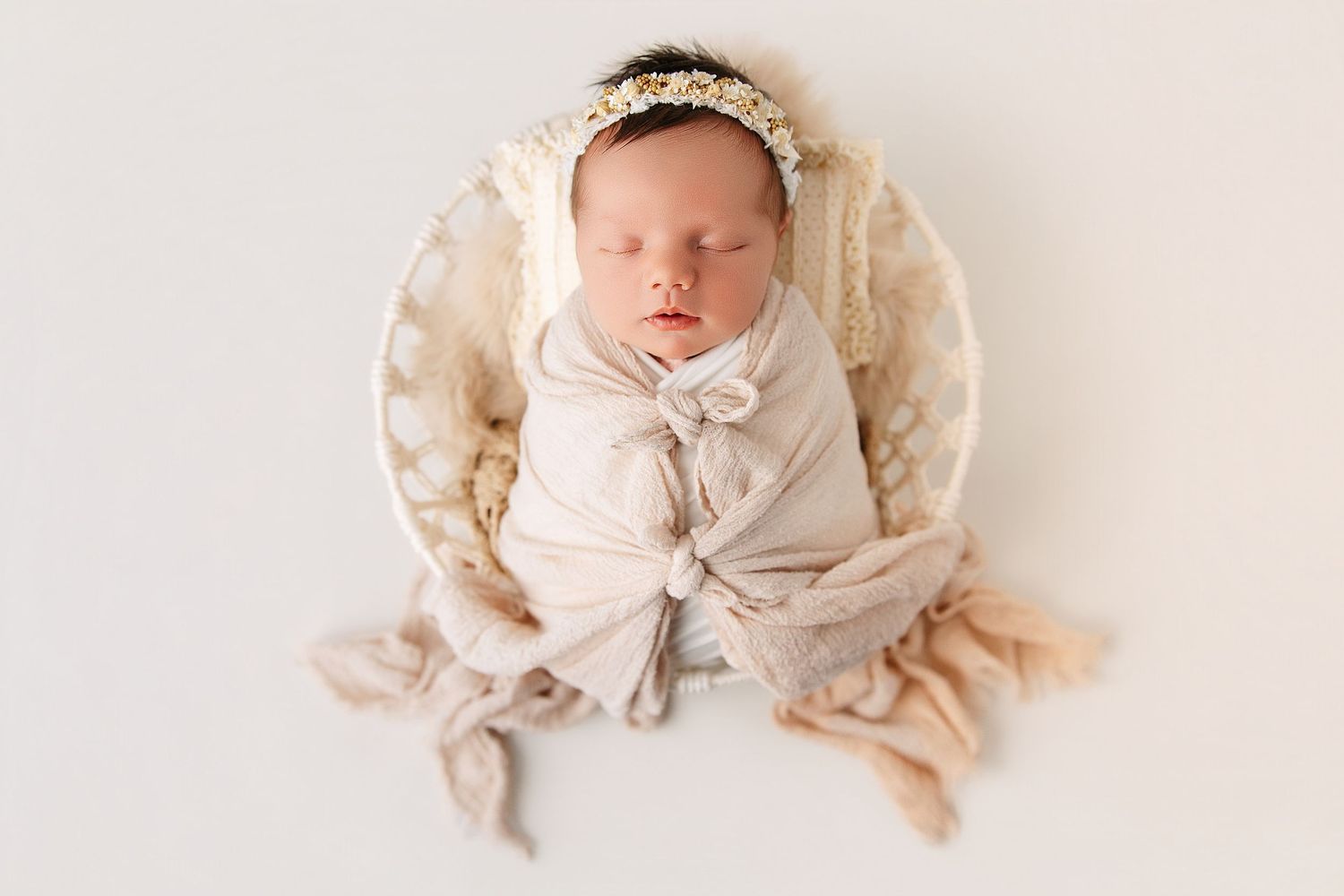 A collection of soft and dreamy newborn baby photos arranged in a horizontal row against a light background.