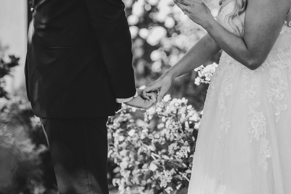 A black and white wedding photo collage showing intimate moments between newlyweds during their special day.