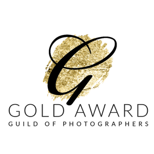 Elegant gold and black logo design for Guild of Photographers featuring a cursive G and textured gold background.
