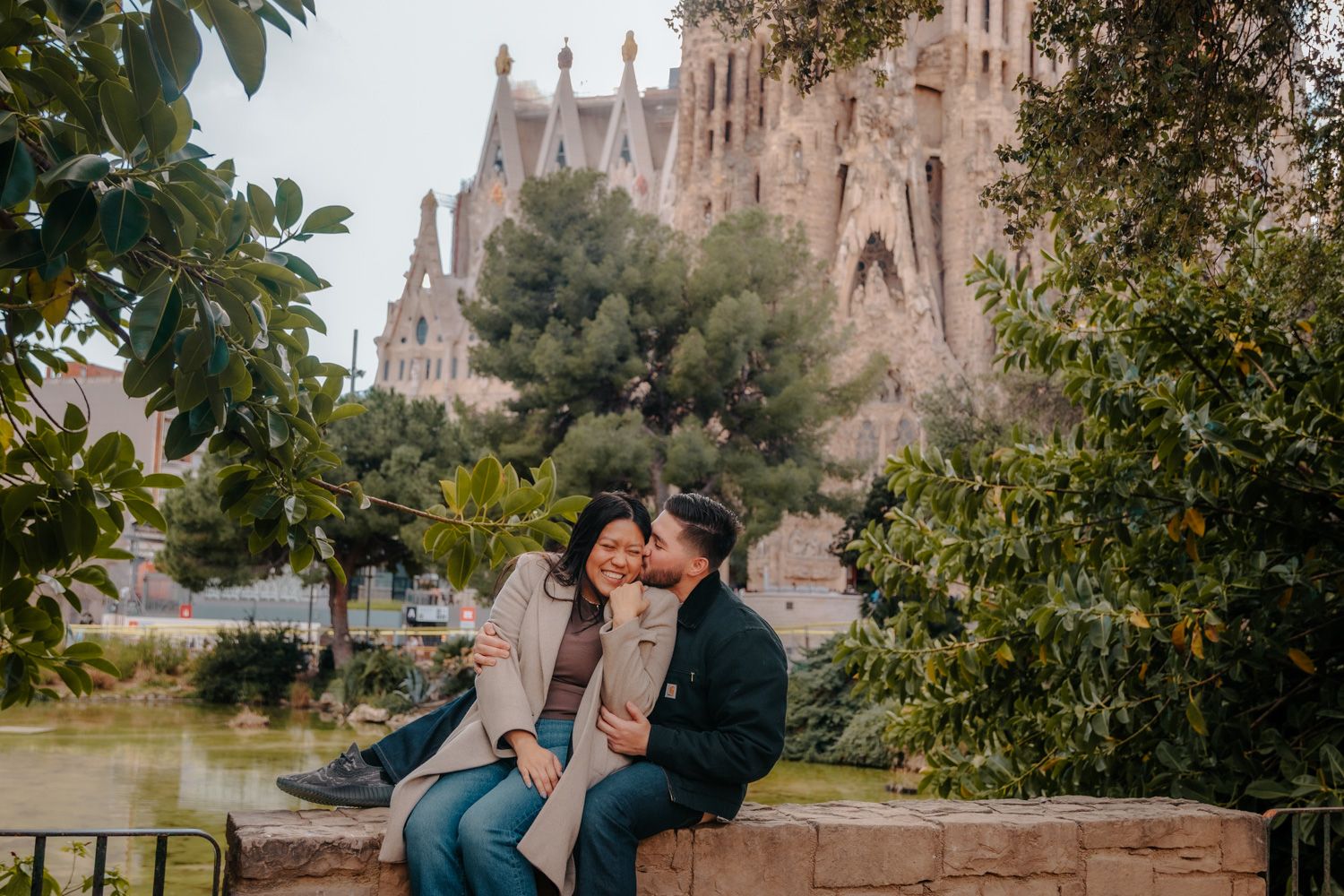 Surprise proposal with Sagrada Familia behind couple at sunrise Barcelona