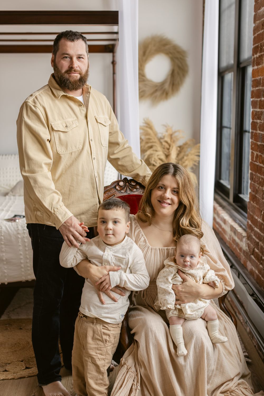 A family poses for newborn family photos at the Little Loft in North Andover, Massachusetts. Chelmsford, Weston newborn photographer