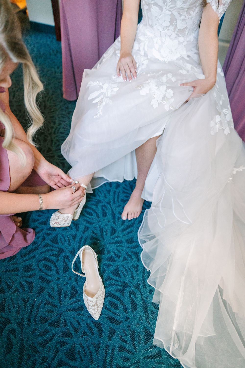 Close-up shots of white wedding shoes and dress details against a blue-green carpeted floor.