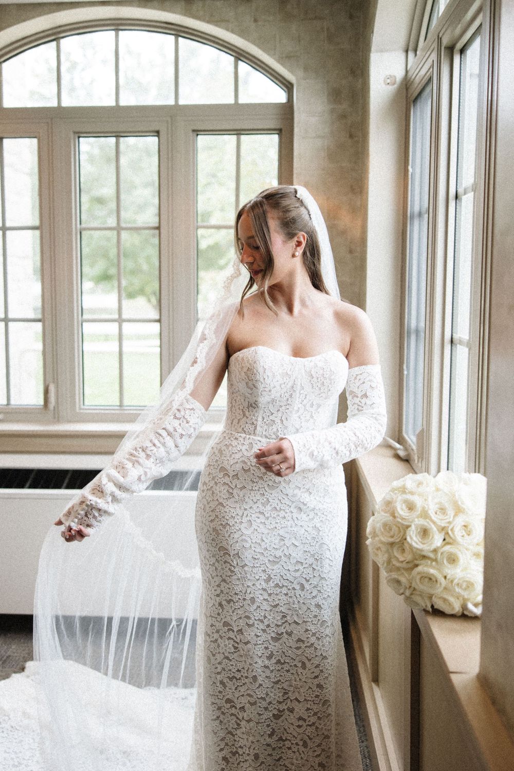 A sequence of bridal portraits showing a lace wedding dress and flowing veil in a sunlit room with windows.