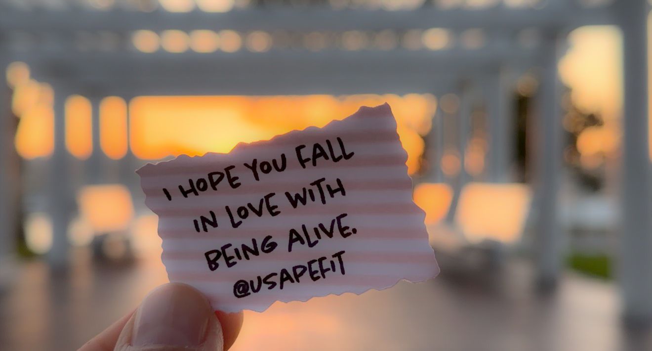 Inspirational quotes and messages written on sticky notes against a blurred sunset background.