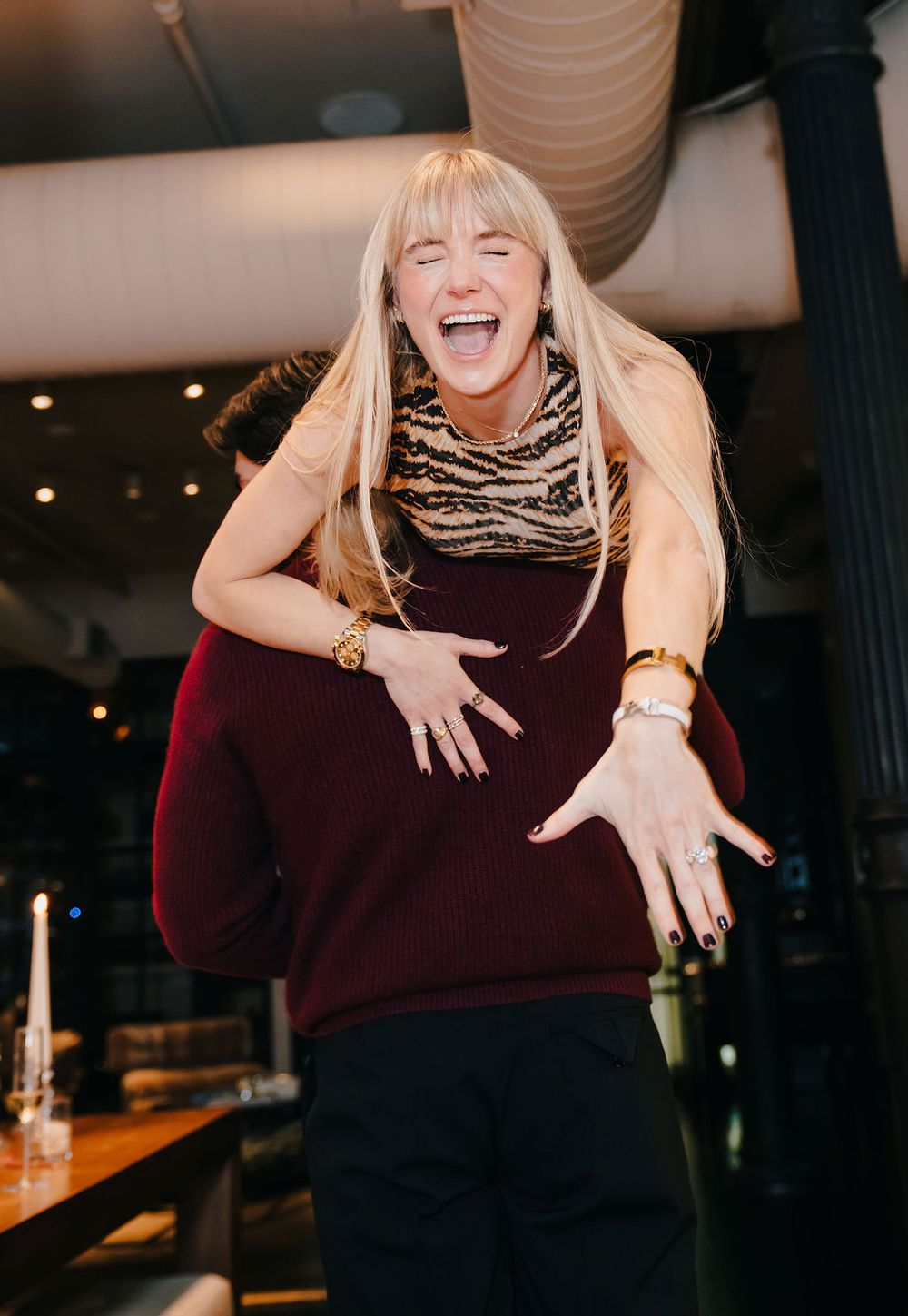 A sequence of expressive poses in a burgundy sweater, showing dynamic movement and gestures against a dark background.
