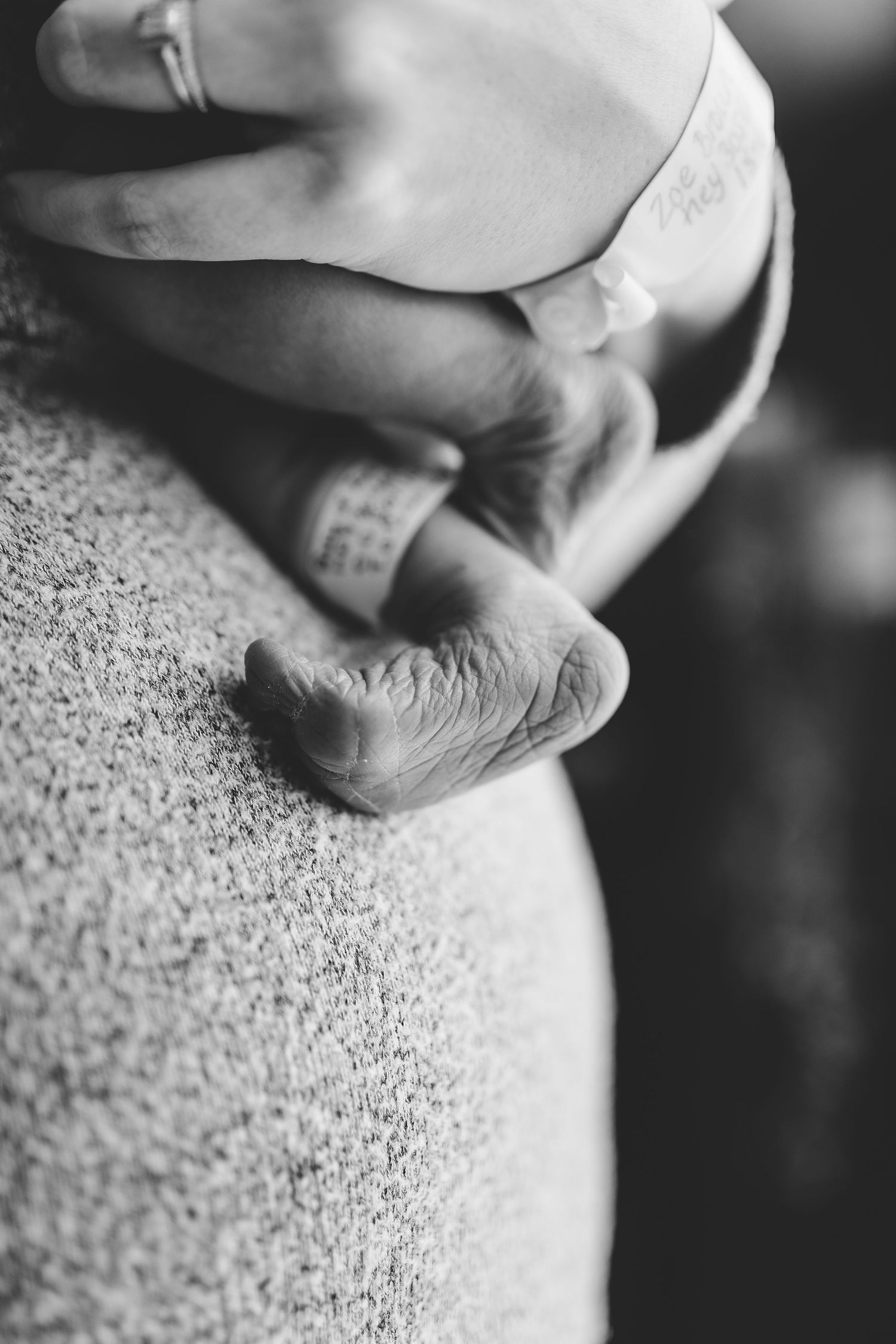 Black and white close-up photographs of feet resting on textured carpet or fabric surface.