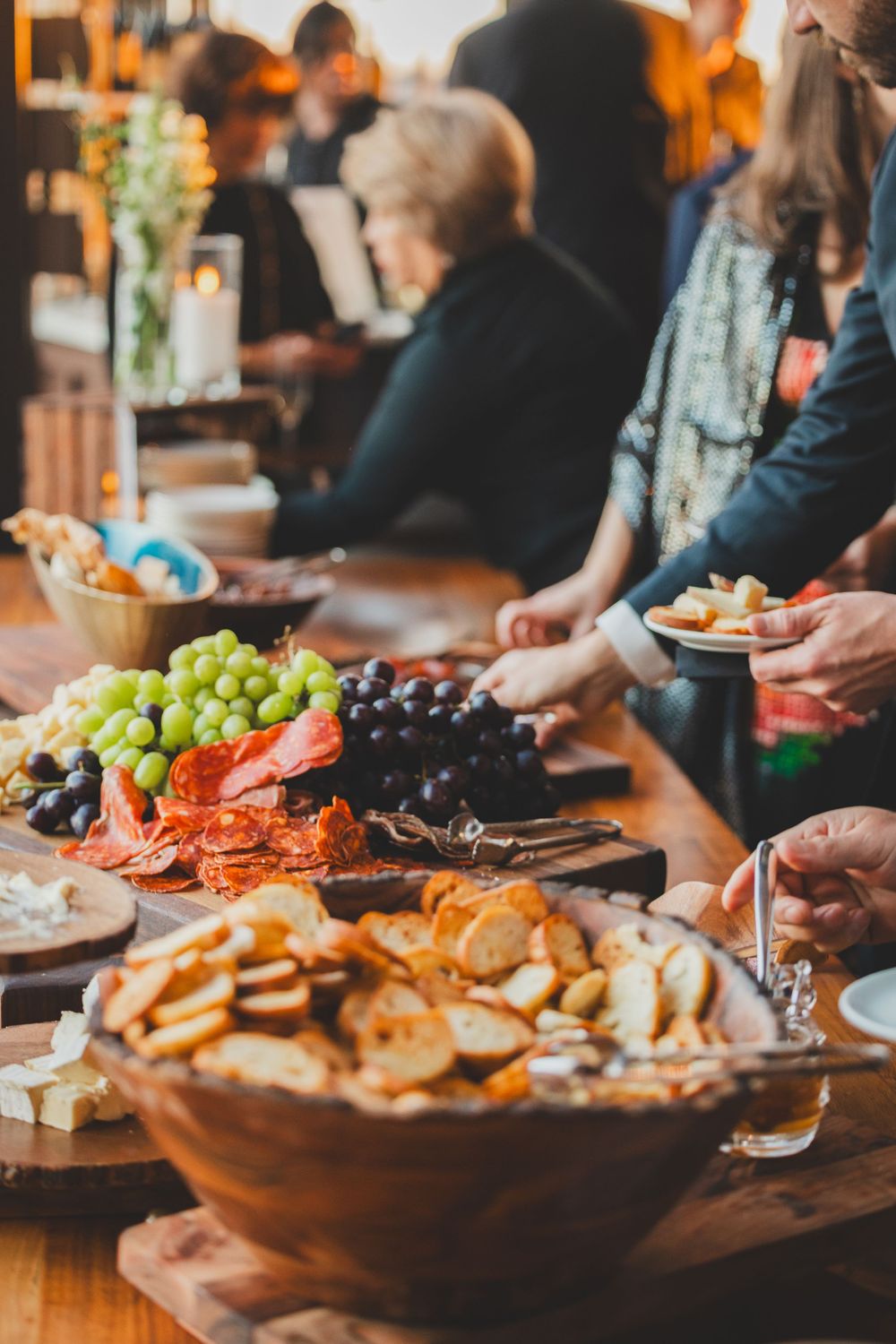 A buffet table spread with appetizers including grapes, crackers, and meats for casual entertaining.