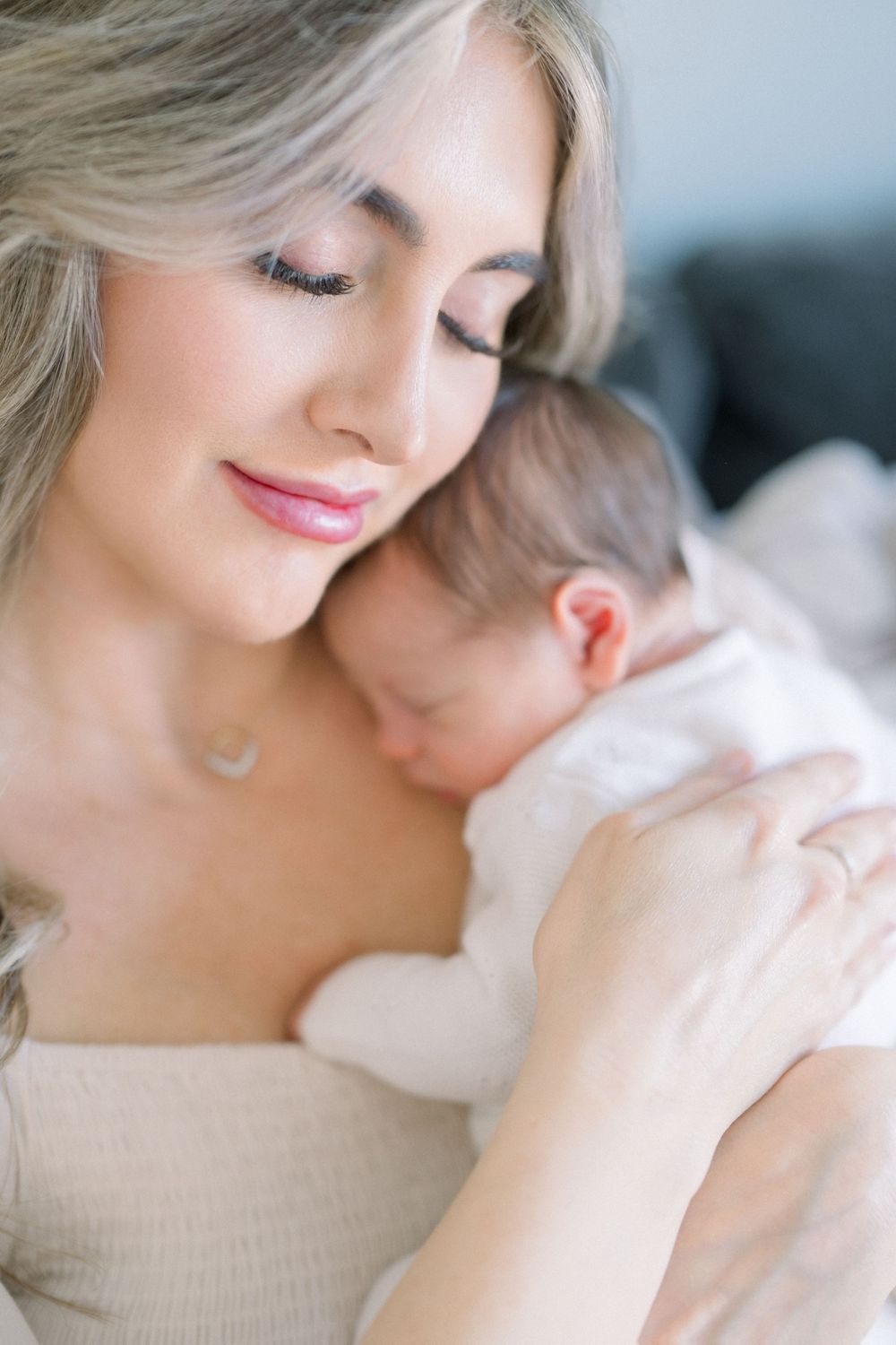 A tender moment captured as a mother holds her sleeping baby close at her newborn session in washington dc