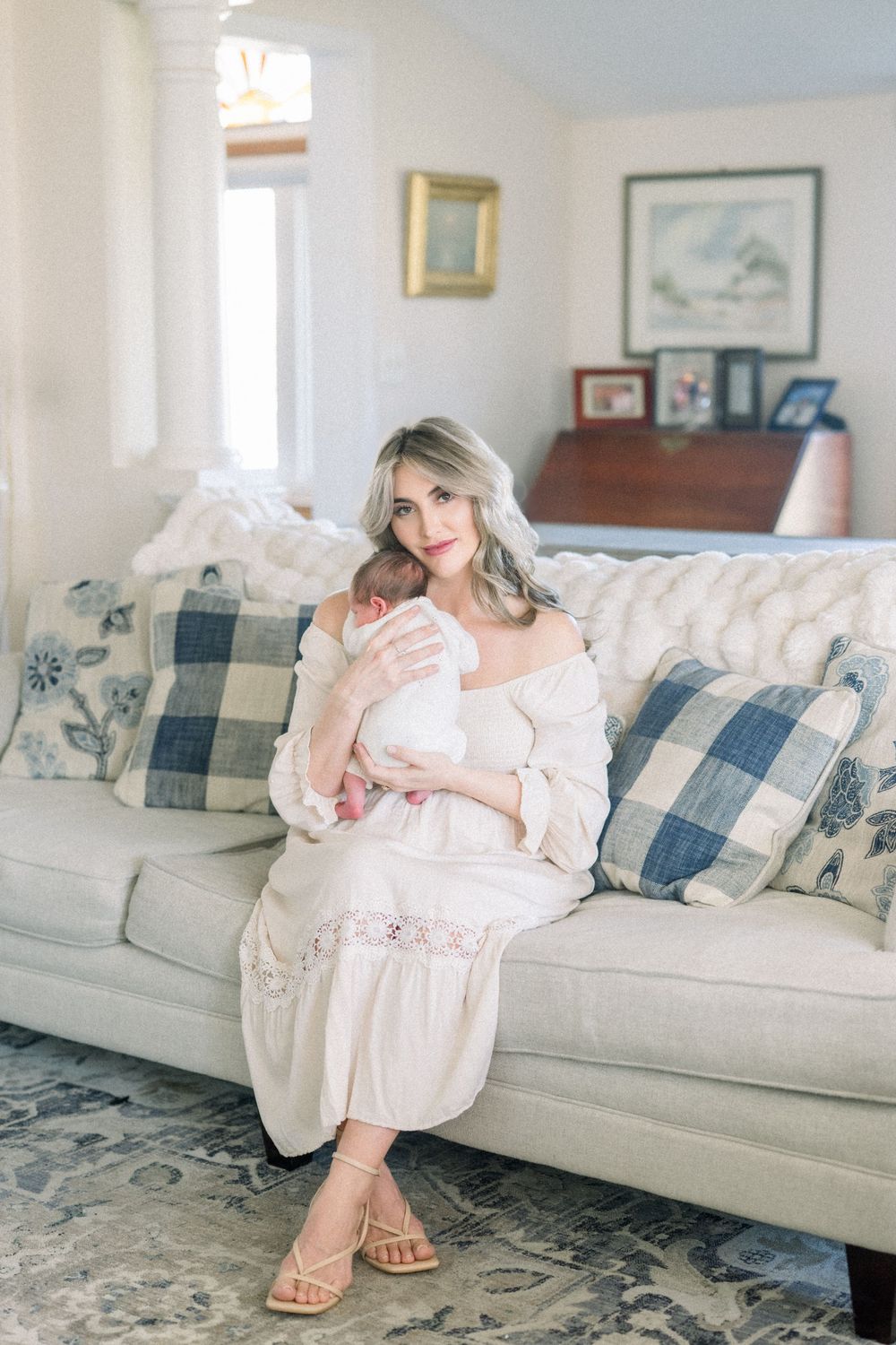 a mother cradling hew newborn at her in-home newborn session in Northern Virginia