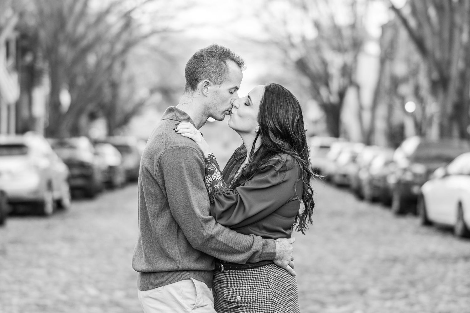 Black and white romantic couple portraits taken on a tree-lined street.