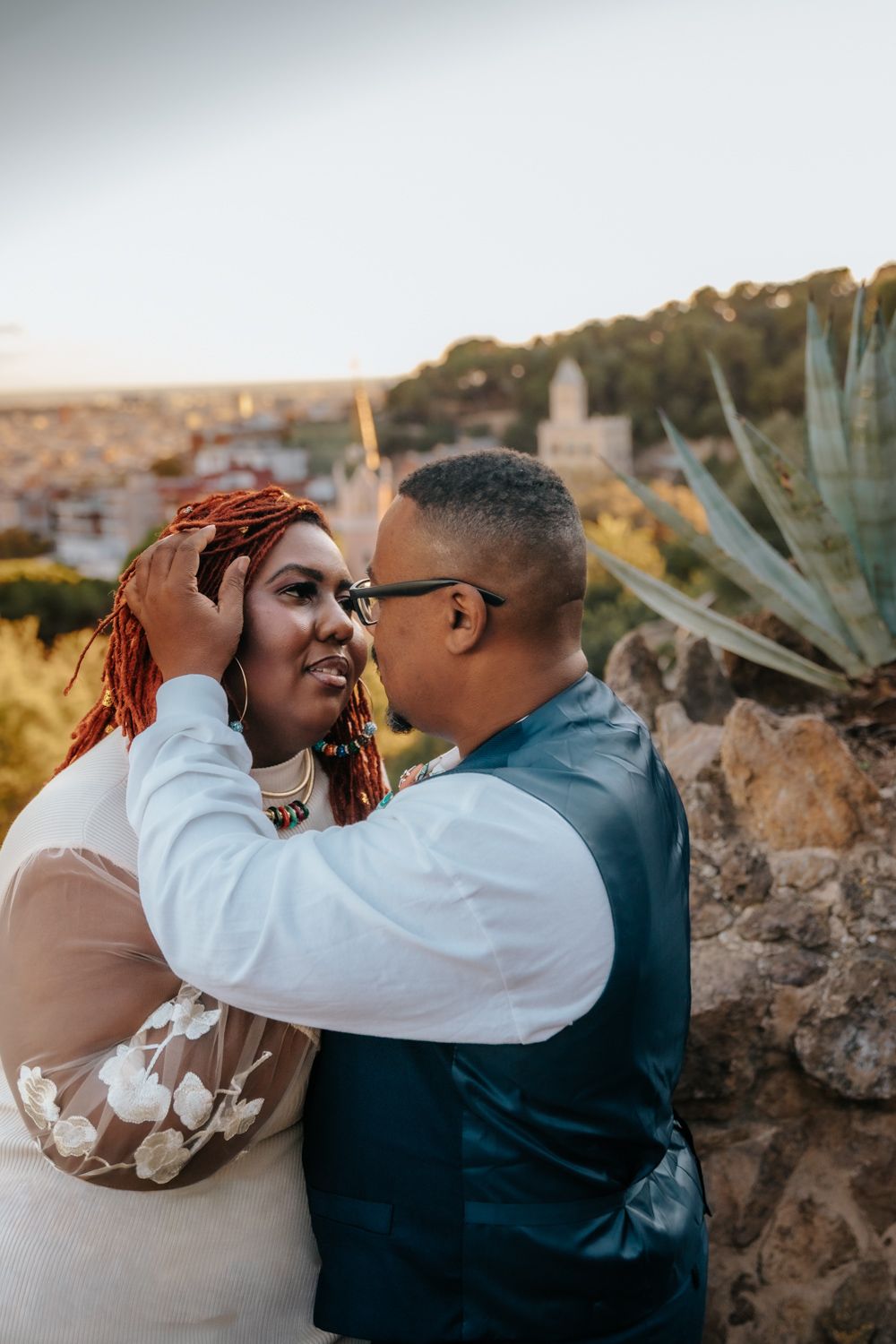 Tender kiss with city skyline backdrop Barcelona Anniversary photoshoot Barcelona BarcelonaLoversPH