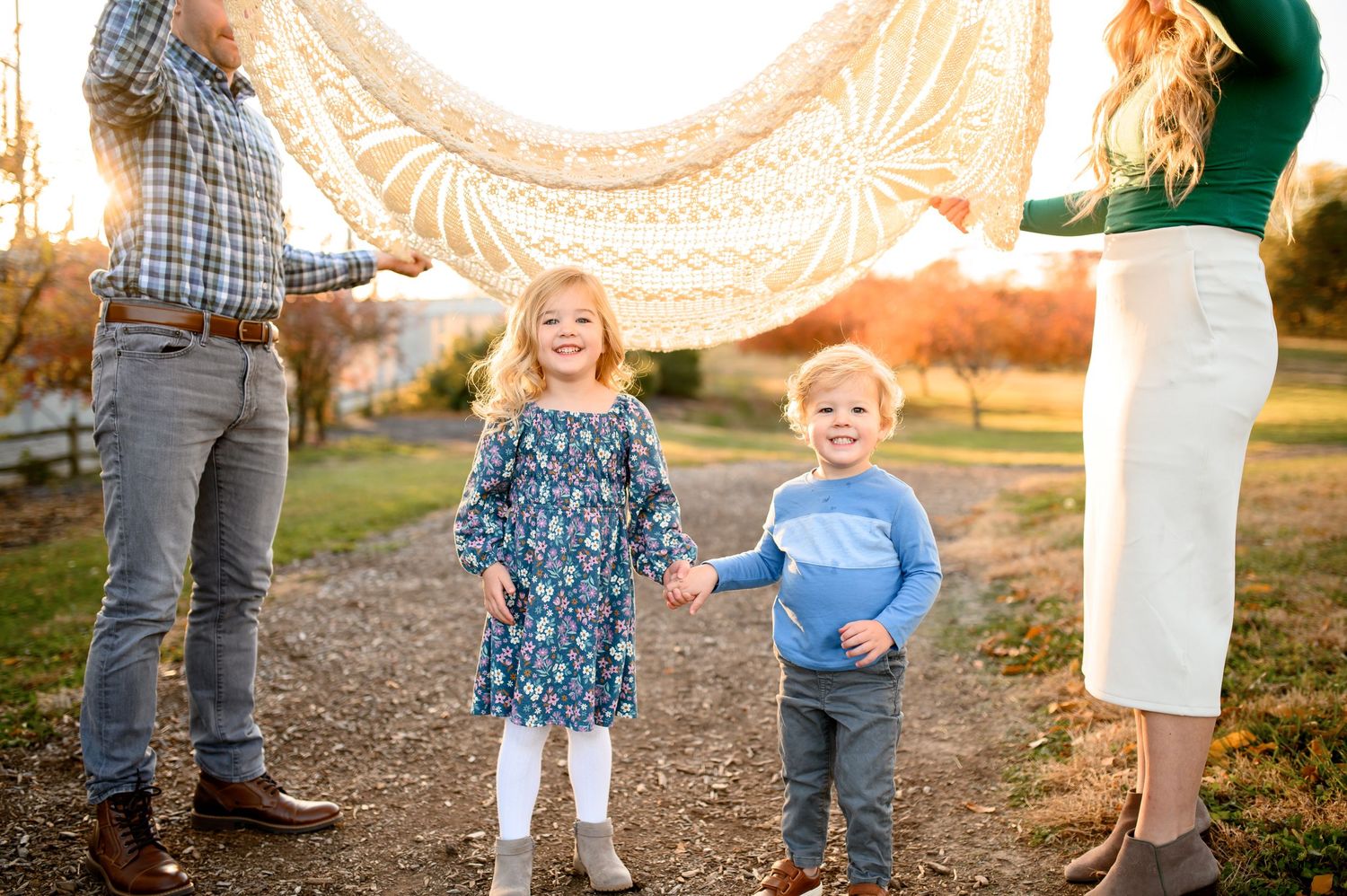 A series of outdoor family photos at sunset showing candid moments on a dirt path with golden light filtering through trees.