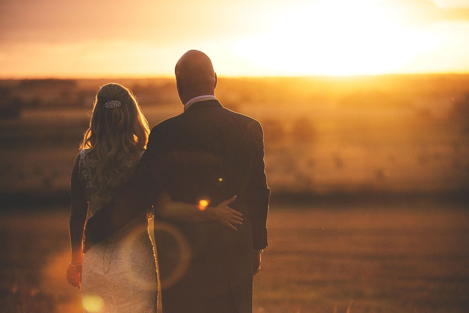 A bride and groom gaze into the sunset for a golden hour portrait, West Tower wedding, Liverpool