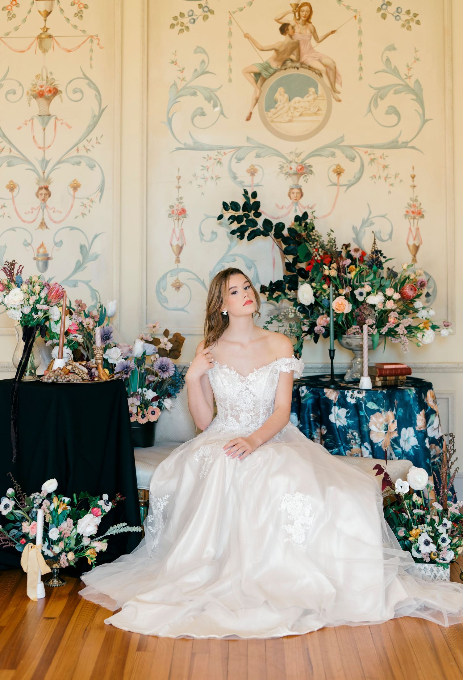 Wedding scene with ornate wallpaper, floral arrangements and romantic decor details.