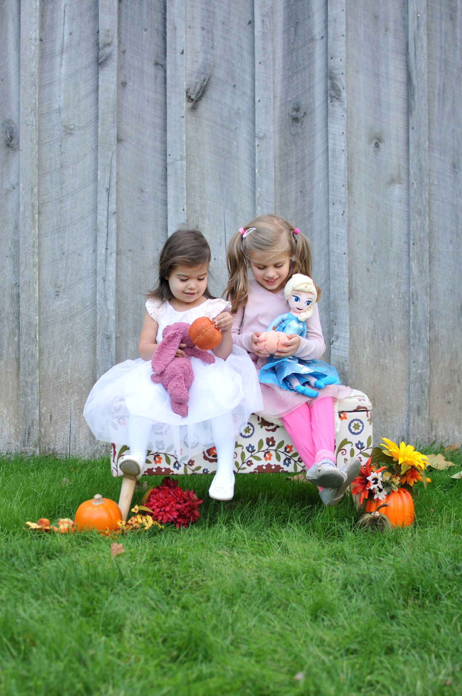 Two girls sitting on bench fall photo