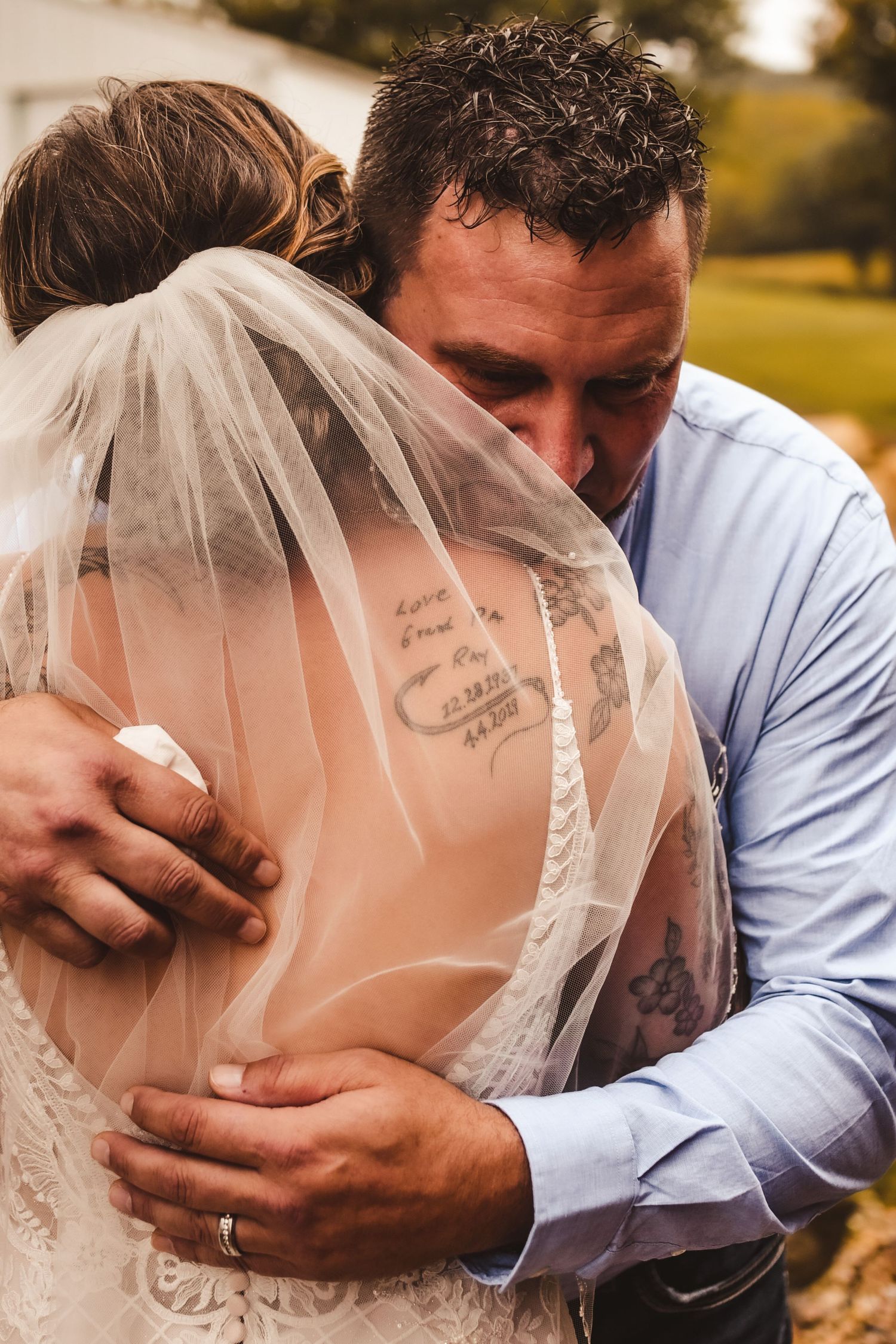 Intimate embrace between couple during emotional wedding moment.