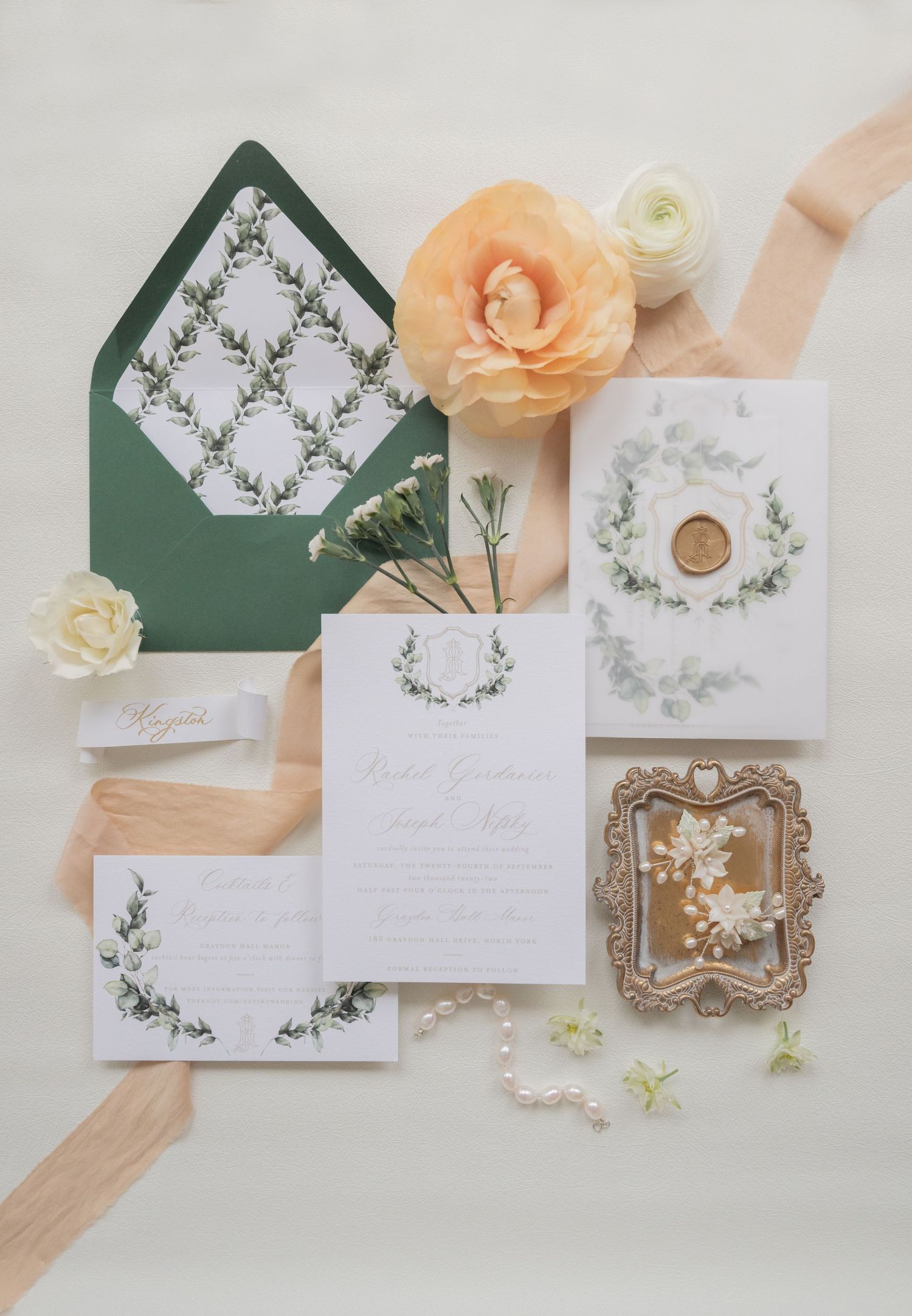 Green and white wedding invitation suite with peach flowers and delicate botanical designs.