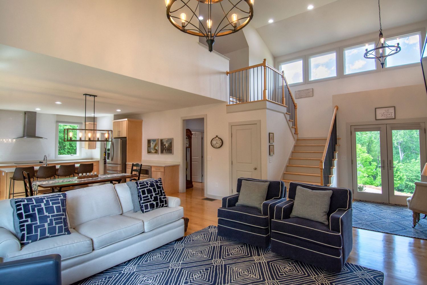 Contemporary open-plan living room with high ceilings and modern furniture. Realestate Photography