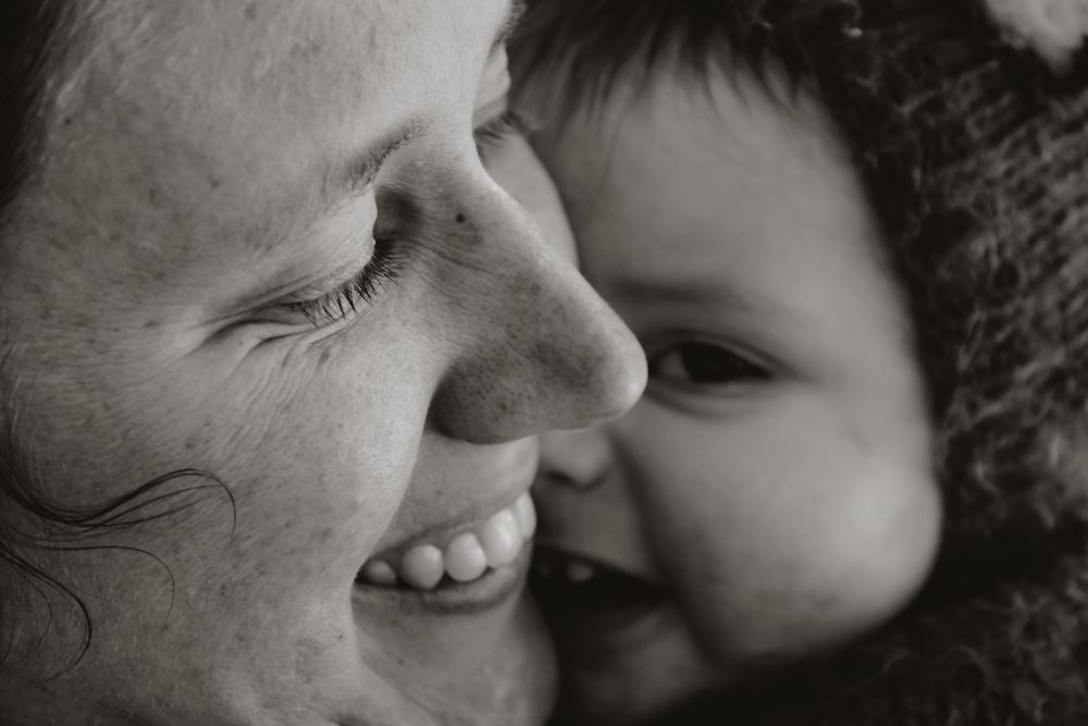 Intimate black and white portrait showing tender moment of affection and laughter.