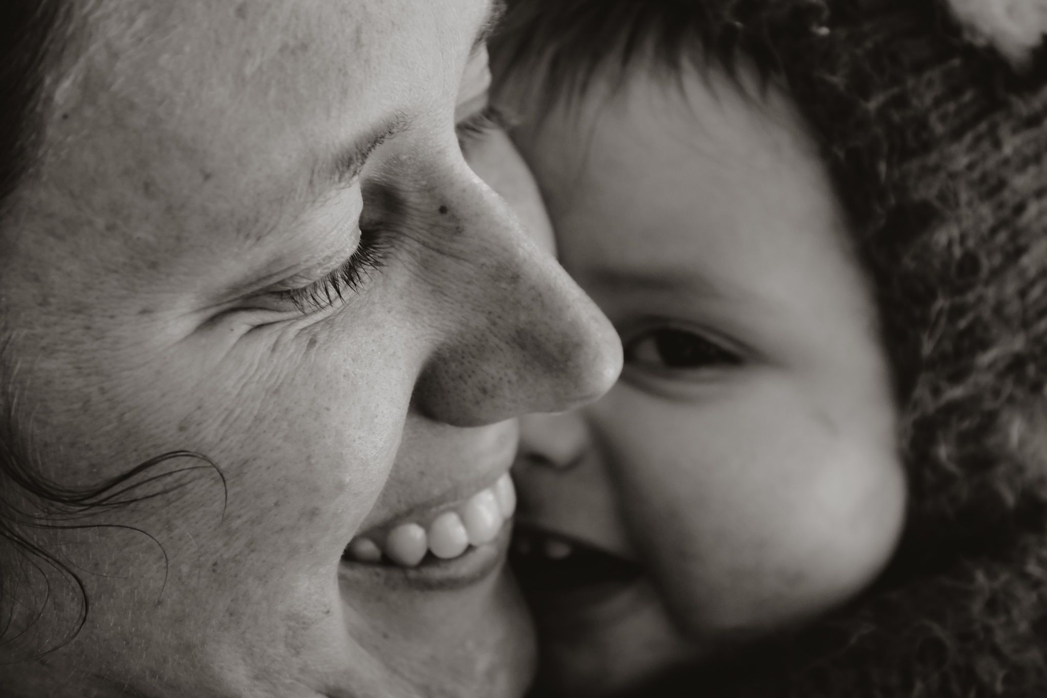 Intimate black and white portrait showing tender moment of affection and laughter.