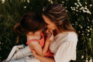 Intimate close-up of tender family moment in golden evening light.