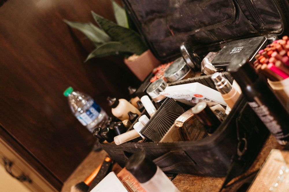 Professional styling tools and equipment arranged on a wooden surface.