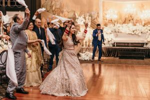 Wedding reception dance floor filled with celebrating guests in formal attire.