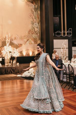 Wedding celebration featuring traditional South Asian bridal attire in pale blue with intricate embellishments.