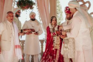 A traditional Sikh wedding ceremony with participants gathered under a decorated mandap.