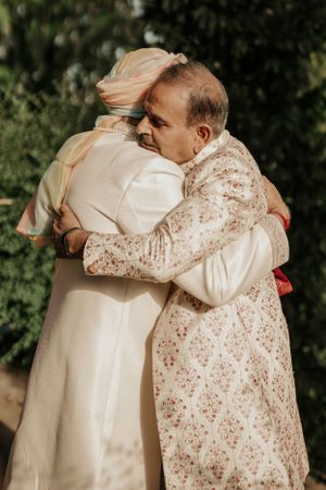 Two people sharing an emotional embrace during a wedding ceremony.