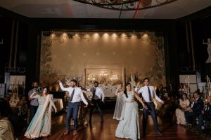 Wedding reception dance floor filled with celebration and joyful dancing.