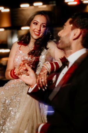 Dancing couple shares a joyful moment at their wedding reception.