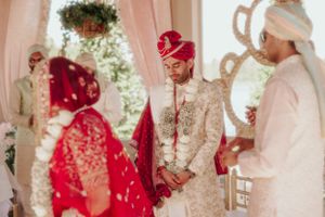Wedding ceremony participants gathered under decorated pavilion during traditional ritual.