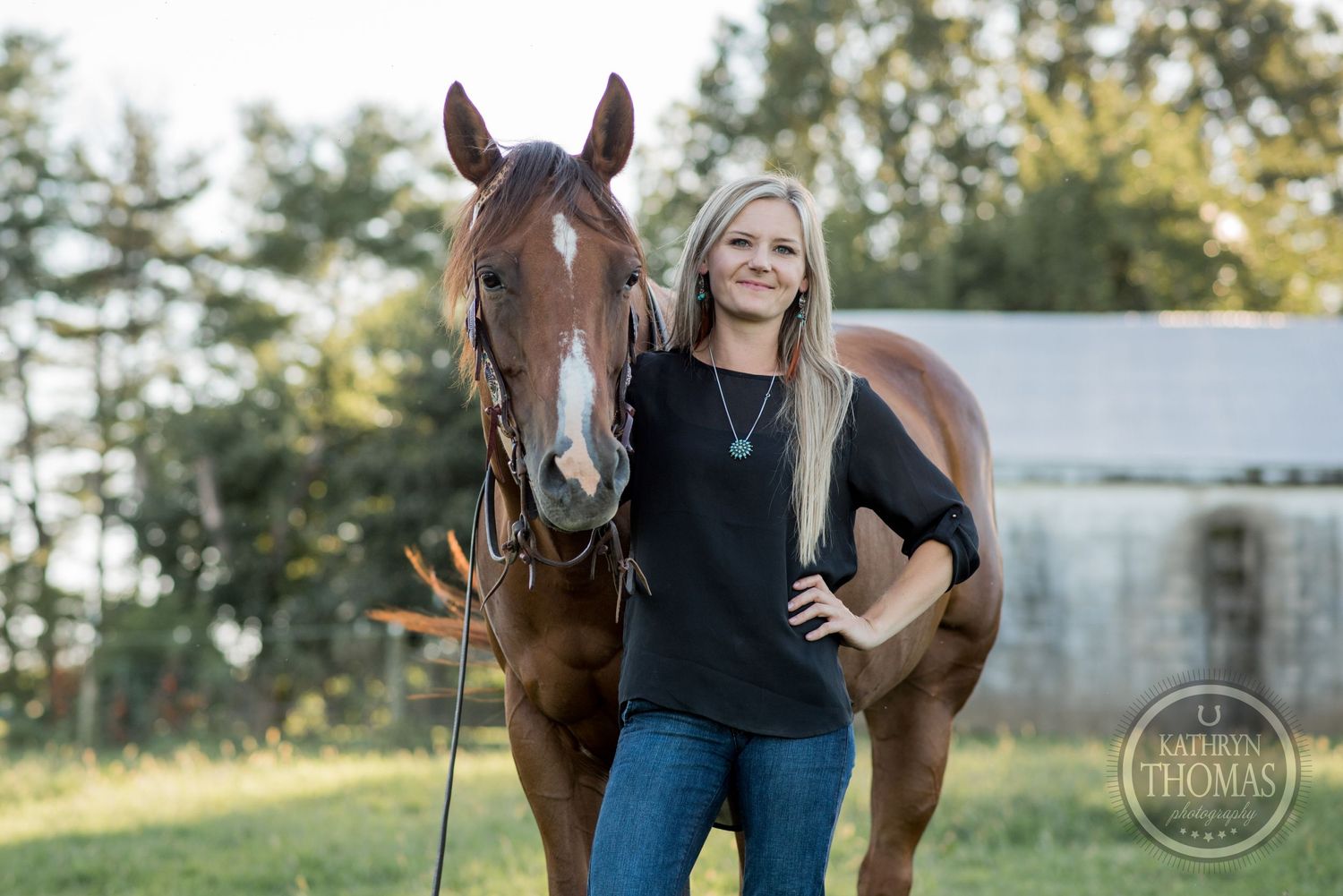 A brown horse and companion share a cheerful moment in an outdoor setting with trees.