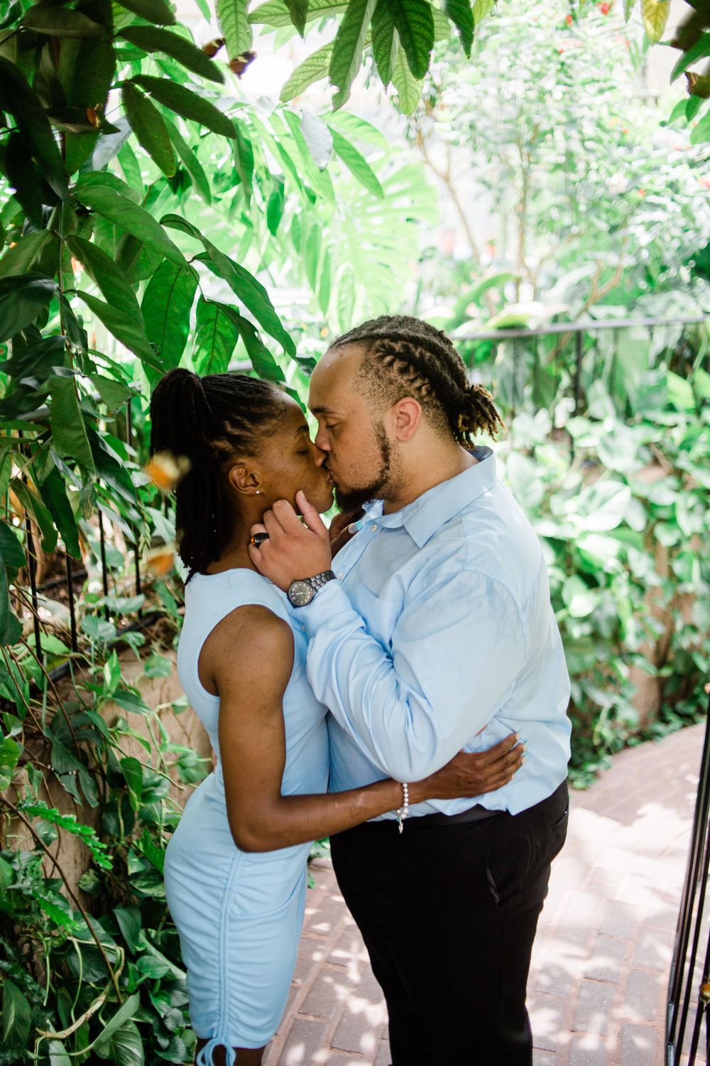 Couple kissing in butterfly pavilion at Callaway Gardens, GA