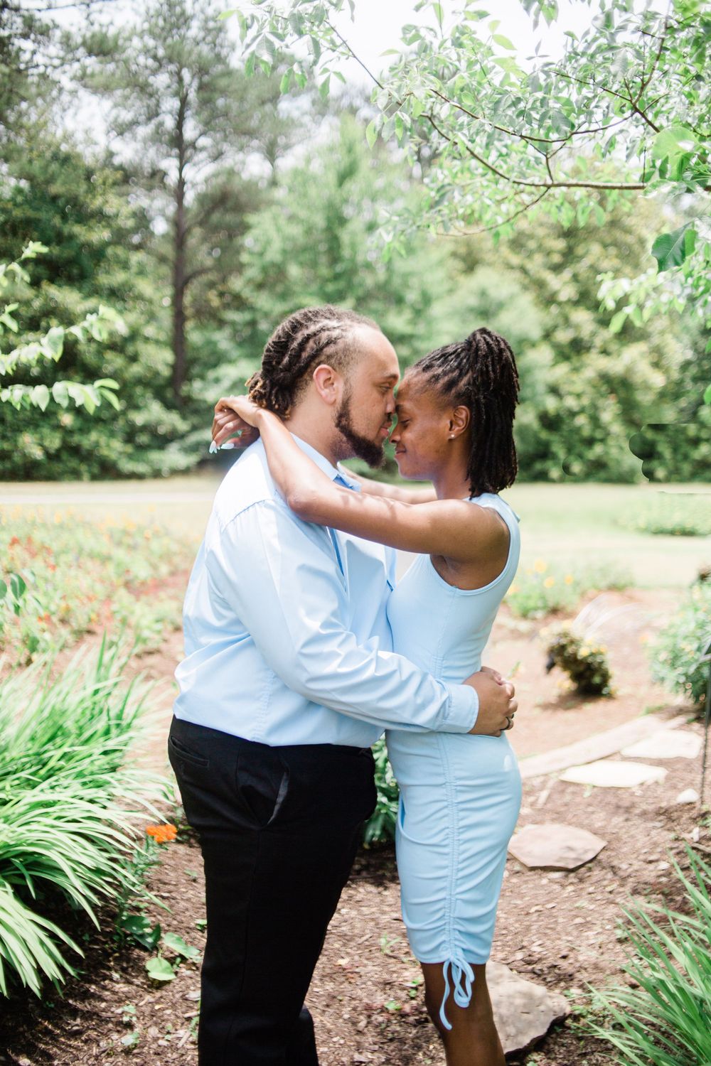 Couple forehead to forehead in front of Callaway Gardens Butterfly Pavilion