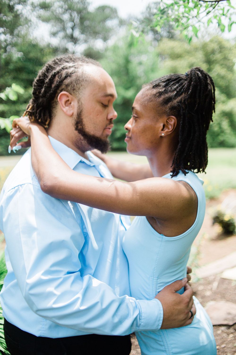 Woman with arms around man's neck Callaway Gardens, GA