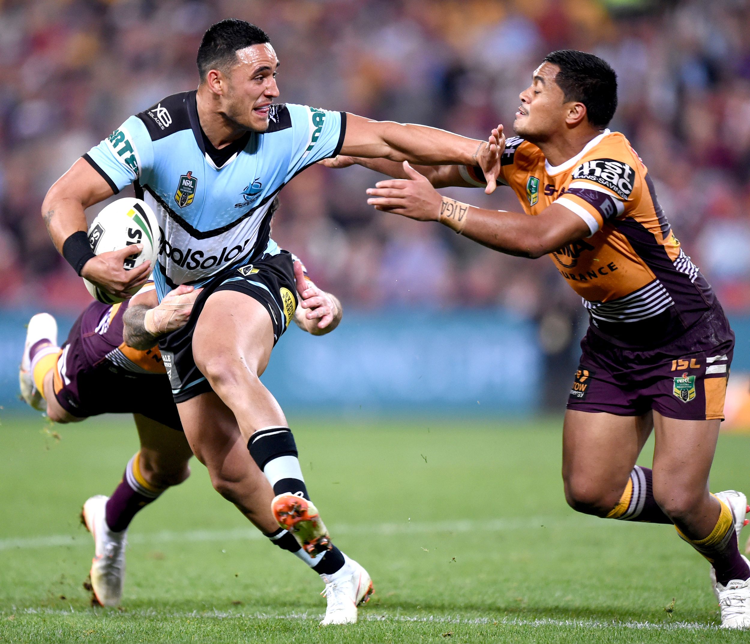 Rugby league player fends away another player