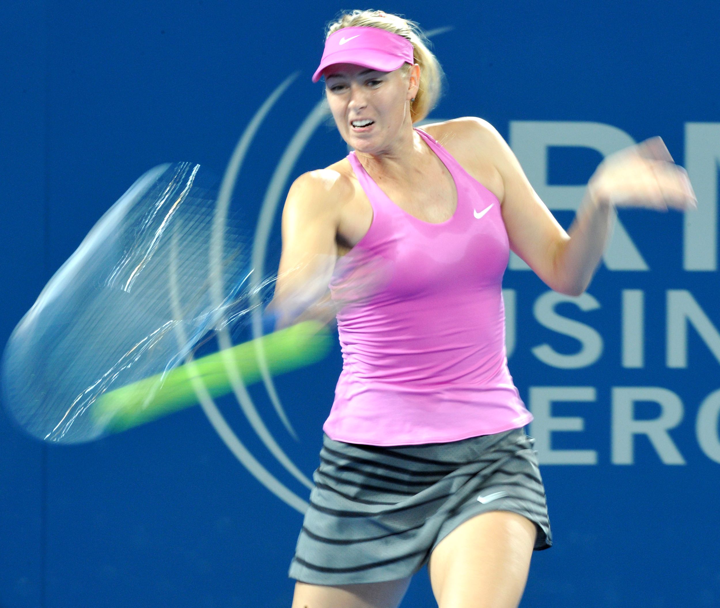 Action blur female tennis player hitting the ball