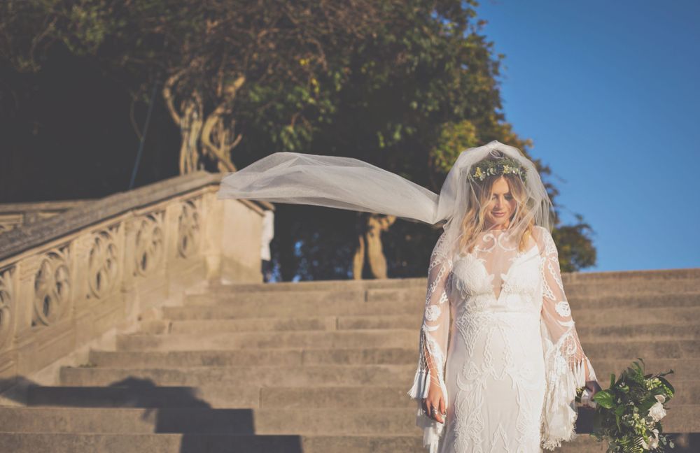 Panoramic sequence of wedding photos on stone steps against blue sky background.