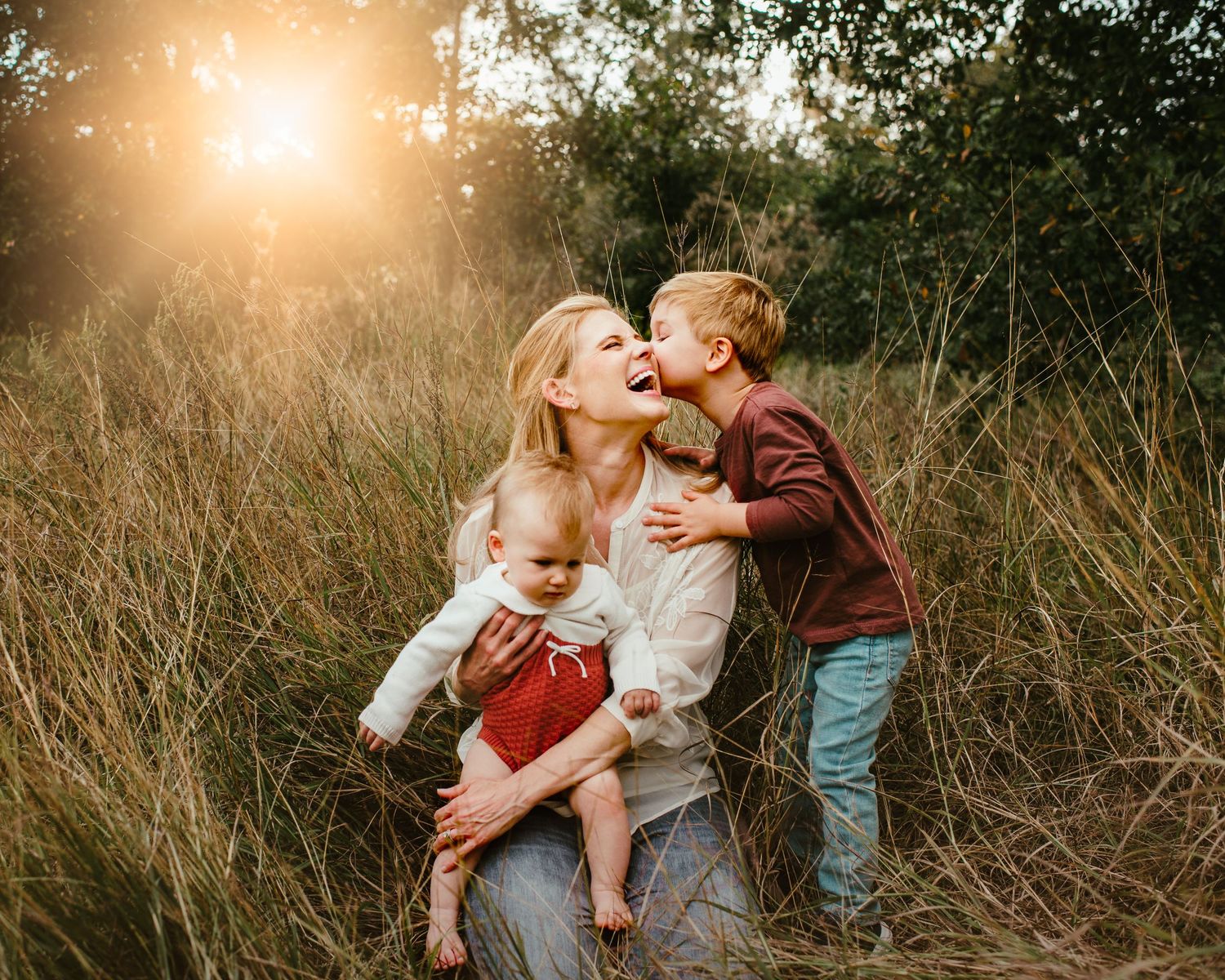 Golden hour family photography session in tall grass.