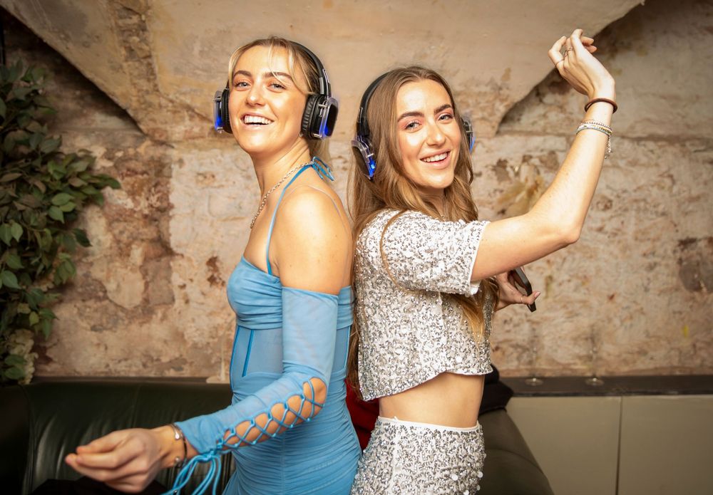Silent disco. party guests. Girls dancing.