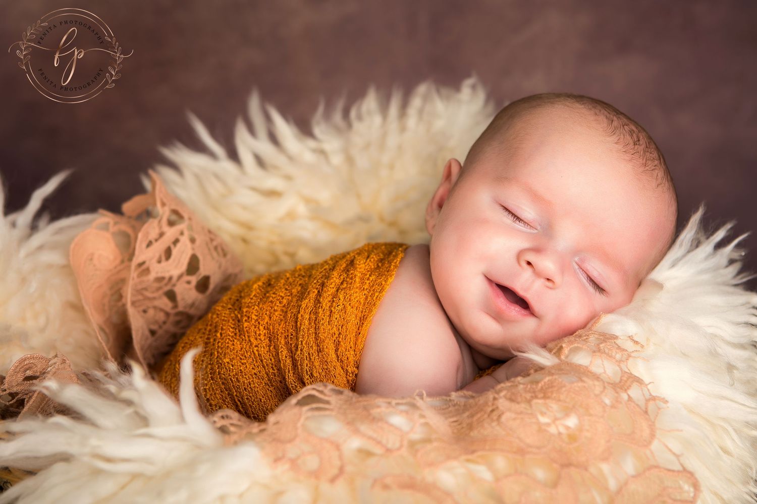 newborn baby sleeping and smiling