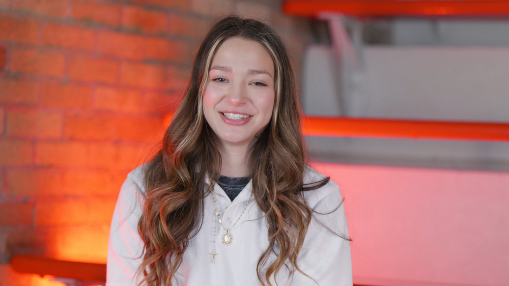 Portrait in bright setting with orange lighting effects.